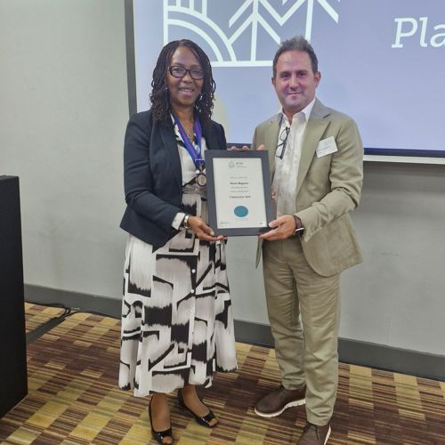 Dr Samer Bagaeen receiving his Fellowship certificate from RTPI President Helen Fadipe at the General AssemblyMBE