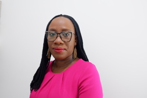 headshot of Olafiyin Taiwo wearing a flourescent pink top