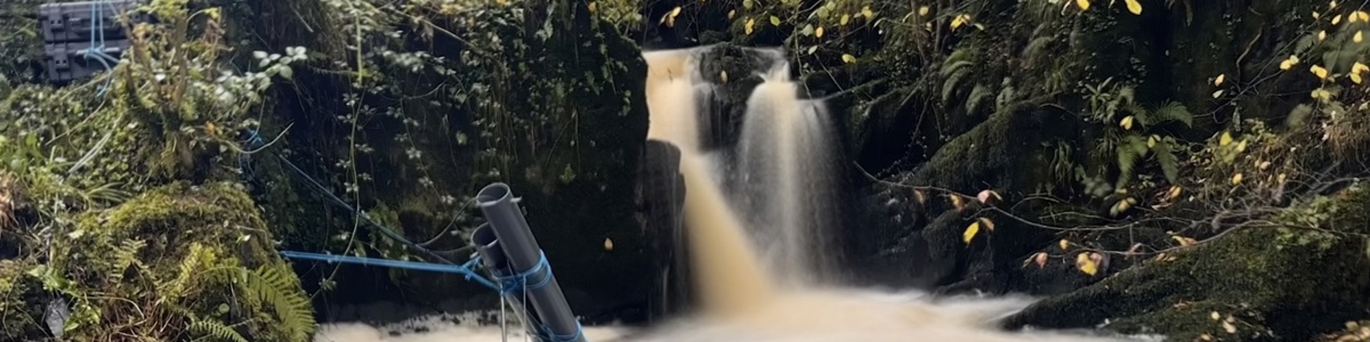 An image of a waterfall in Wales which includes measuring tubes aimed at monitoring water pollution