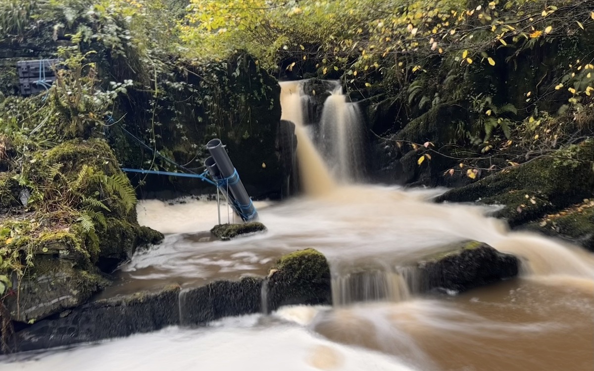 An image of a waterfall in Wales which includes measuring tubes aimed at monitoring water pollution